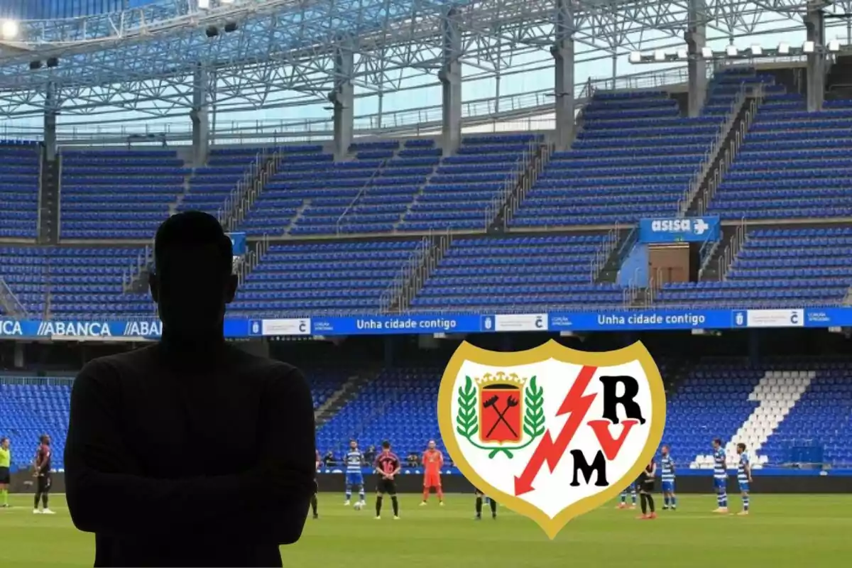 Una persona en silueta frente a un estadio de fútbol vacío con el escudo del Rayo Vallecano en primer plano.