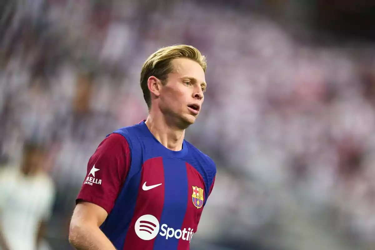 Jugador de fútbol con uniforme del FC Barcelona en el campo de juego.